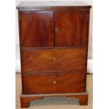 A small Georgian mahogany bedside cupboard, the pair of doors above two drawers, brass handles, on