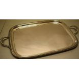 A rectangular silver tray with a gadroon border and two cast handles, 22in (56cm across) Maker Henry
