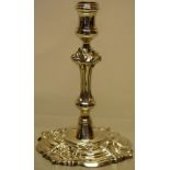 An early Victorian cast rococo revival silver taperstick, in the manner of Paul De Lamerie, with