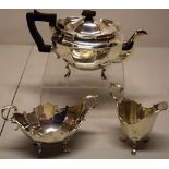 A small oval silver three piece tea service, the panelled sides engraved a stags head crest, the