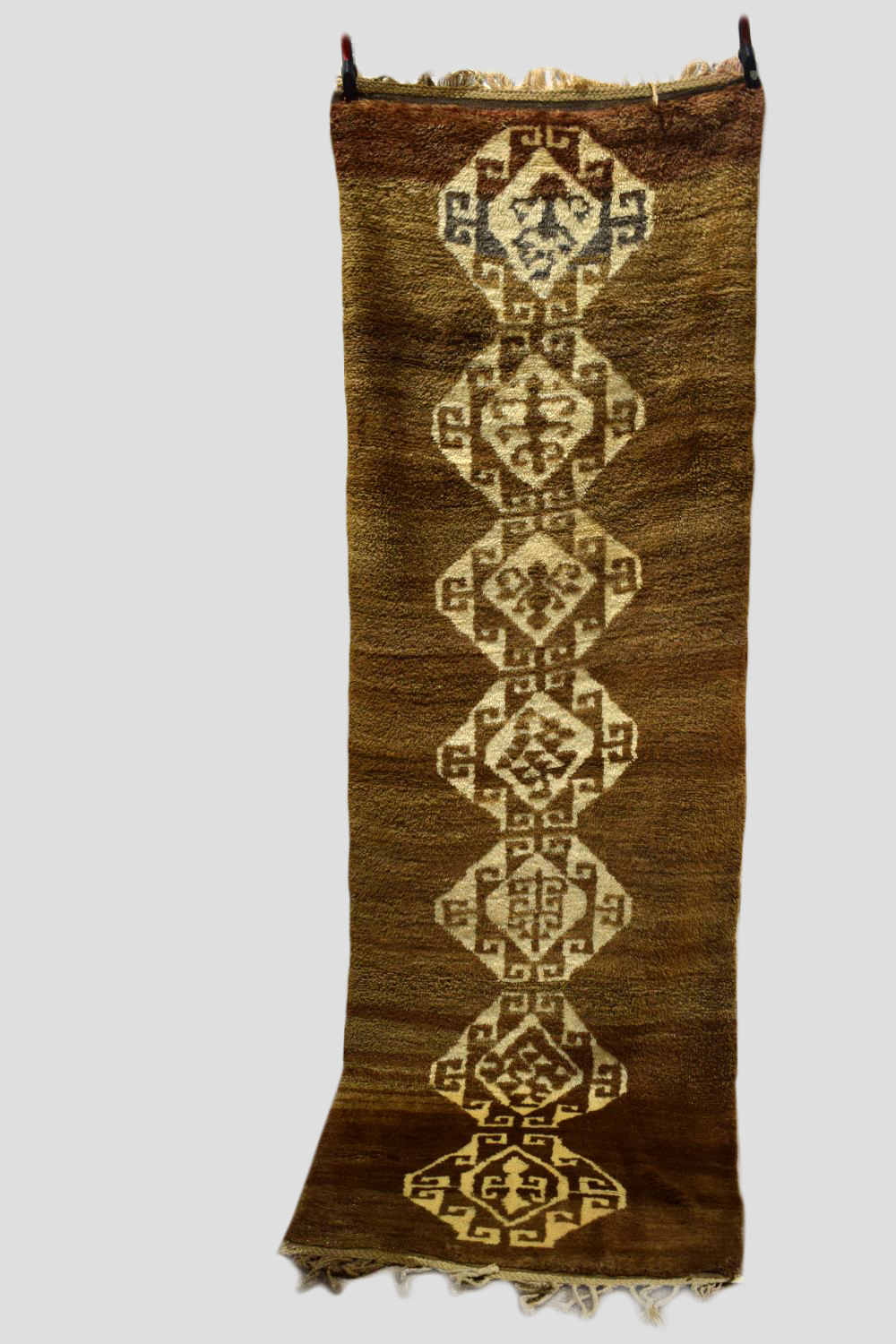 Anatolian tulu runner, 20th century, 10ft. 3in. x 3ft. 5in. 3.12m. x 1.04m. Pale walnut field with