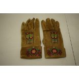 Pair of Native American Indian buckskin gloves, the turned back cuff, back and thumb finely