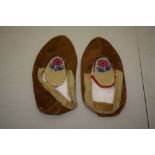 Pair of ladies small buckskin mocassins, with turned over edges, 9in. Long x 4 1/2 in. Wide; 23cm. X