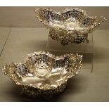 A pair of late Victorian silver quatreform dessert baskets, the pierced fretwork shaped sides with