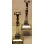 A pair of early nineteenth century Indo Portugese silver candlesticks, with petal banded cylindrical