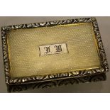 A George IV silver and parcel gilt rectangular table snuff box, engine turned with a chased