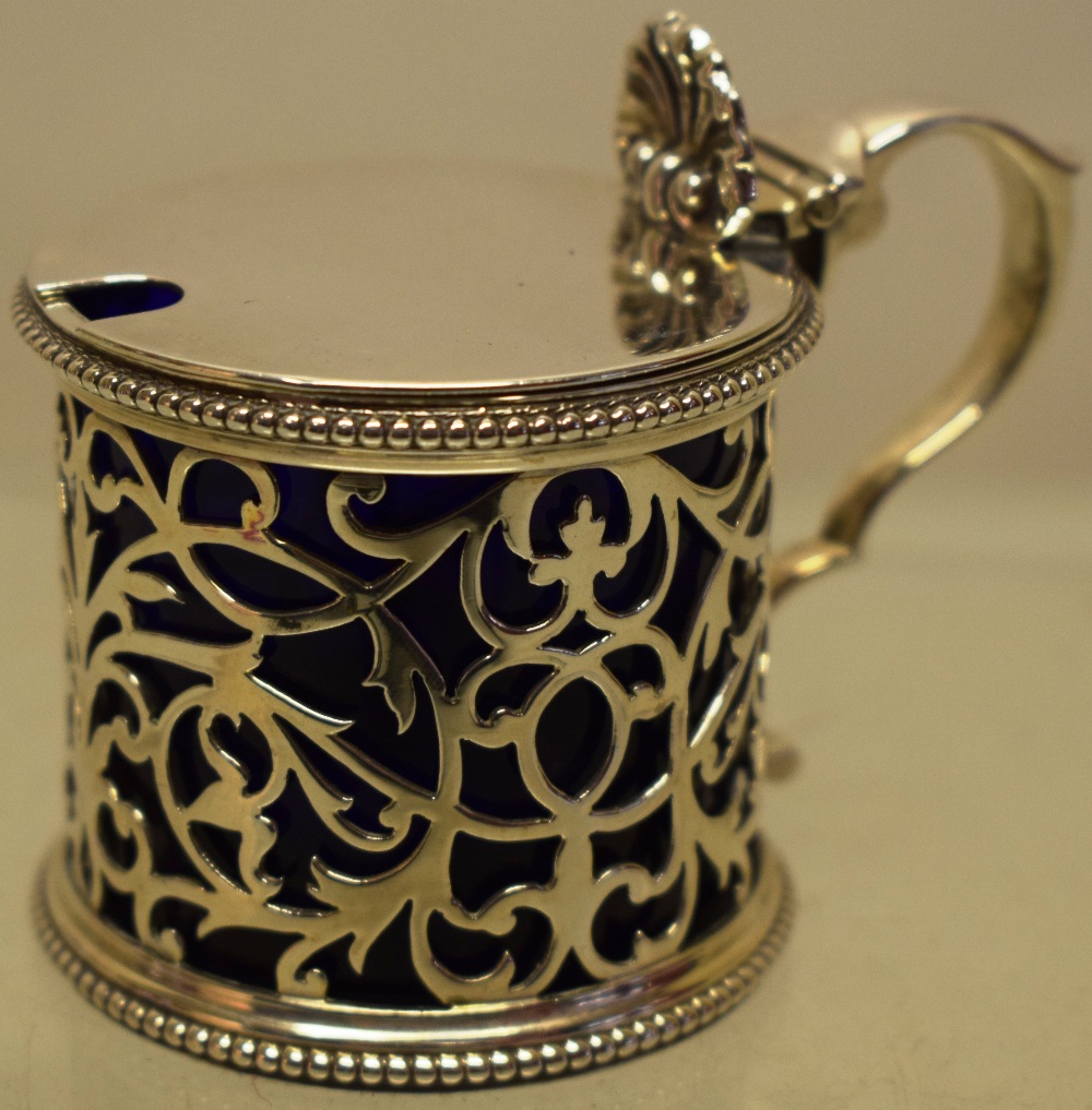 A Victorian silver drum shape mustard pot, the pierced fretwork side with bead edges, the hinged lid