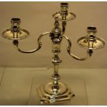 A silver copy of an early Georgian candelabrum, the three branches with spool shape candleholders, a