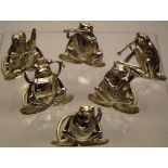A late Victorian novelty six piece menu holder set, of a frog band, playing a variety of musical