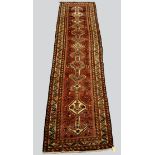 Fars runner, south west Persia, mid-20th century, 13ft. 3in. x 3ft. 6in. 4.04m. x 1.07m. Pink/red