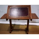 A William IV faded mahogany sketching table, with an easel back raised flap inset maroon gilt tooled