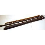 Two antique ethnic hardwood sticks, one in the form of a harpoon, 41in (104cm) and 39in (99cm) (