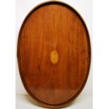 A George III mahogany oval tray, the centre marquetry inlaid the Prince of Wales, plumes within a