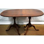 A mahogany extending dining table, in eighteenth century style, the 'D' shape rectangular top with a