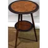 A late Victorian art design walnut occasional table, with ebonized borders, on three ring turned