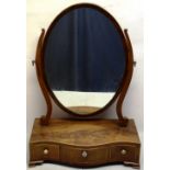 A Sheraton mahogany oval swing toilet mirror, inlaid stringing, the glass on scrolling supports, the