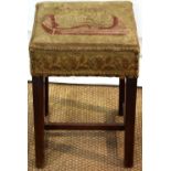 A Sheraton mahogany piano stool, the rectangular stuffed over seat covered in needlework,