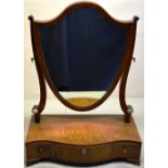 A Sheraton mahogany swing toilet mirror, the shield shape glass on scroll supports, the serpentine