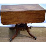 A Regency mahogany supper table, the faded rectangular top crossbanded in rosewood, a fluted edge