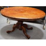 A Victorian rosewood veneered loo table, the faded oval tilt top, on a bulbous stem to four