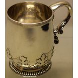 A Queen Anne silver mug, with cut card work to the body, a cast scroll handle with chased foliage