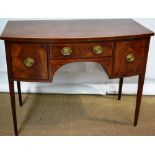A Sheraton mahogany veneered bow fronted dressing table or writing table, inlaid stringing fitted