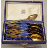 A set of six Soviet Russian silver gilt coloured metal teaspoons, with coloured enamel foliage to