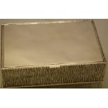 Gerald Benny. A modern designer silver rectangular box, the sides and base with textured bark
