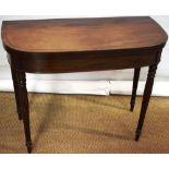 A Regency mahogany tea table, inlaid ebony stringing, the 'D' shape fold over flap top on a