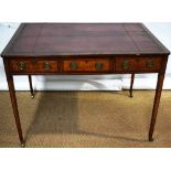 A Sheraton period satinwood veneered library writing table, the rectangular top inset old wine