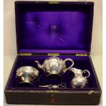 A Victorian ladies matched silver tea service, the circular teapot with repousse pendants of