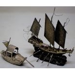 A miniature nineteenth century Chinese silver model of a war junk, carrying deck cannon, oars and