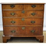 An early eighteenth century walnut veneered chest of two short and three long graduated drawers,