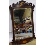 A late nineteenth century mahogany fret frame mirror, the bevelled edge rectangular plate with a