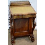 A Victorian walnut davenport, the top with a lidded ogee sided stationary compartment, with a