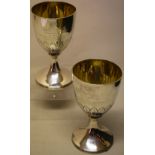 A pair of George III Scottish silver hare coursing goblets, the bowls engraved a vignette of a