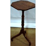 An early nineteenth century yew wood occasional or lamp table, the square top with canted corners,