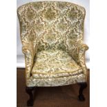 A mid eighteenth century style wing armchair, with a curved back, down swept arms, the sprung seat