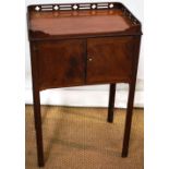 A George III Chippendale mahogany bedside pot cupboard, the pierced gothic galleried rectangular