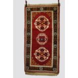 Tibetan 3-medallion rug, inner Asia, circa 1940s-50s, 5ft. 10in. X 3ft. 1.78m. X 0.91m. The dark red