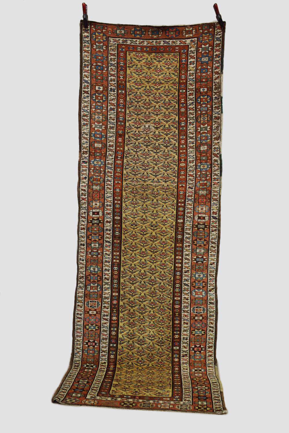 Kurdish runner, north west Persia, early 20th century, 10ft. X 3ft. 7in. 3.05m. X 1.09m. Overall