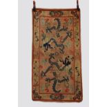 Tibetan 'dragon' rug, inner Asia, early 20th century, 5ft. X 2ft. 8in. 1.52m. X 0.81m. Overall