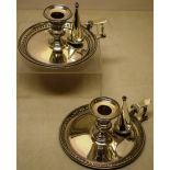 A pair of Victorian silver bedroom chamber candlesticks, the beaded borders with a raised band of