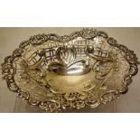 A late Victorian silver ovoid sweetmeat dish, the pierced fretwork sides with repousse scrolls, a