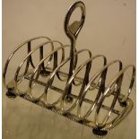A Victorian silver toast rack, with beaded borders, the six divisions with a central ring handle, on