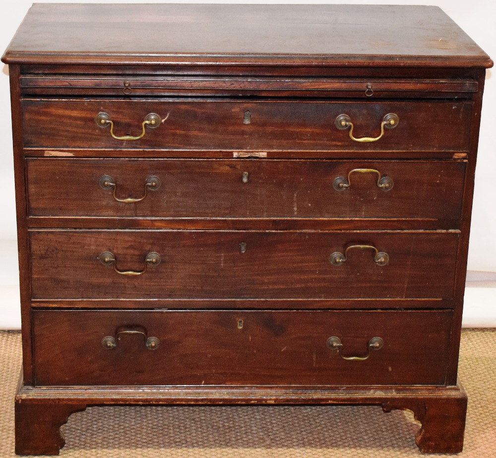 An early nineteenth century mahogany chest of low proportions, fitted a brushing slide above four