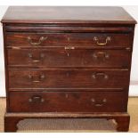 An early nineteenth century mahogany chest of low proportions, fitted a brushing slide above four