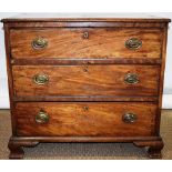 A small late eighteenth century faded mahogany dressing commode, the crossbanded top above three