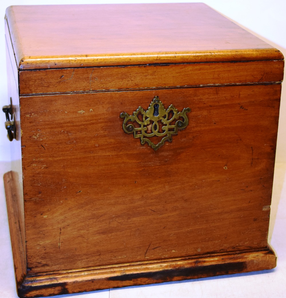 An early nineteenth century faded mahogany square travelling cellarette, the figured hinged lid