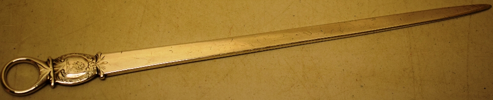 A George III silver meat skewer, with a crested cartouche to the ring terminal, 12in (30.5cm)